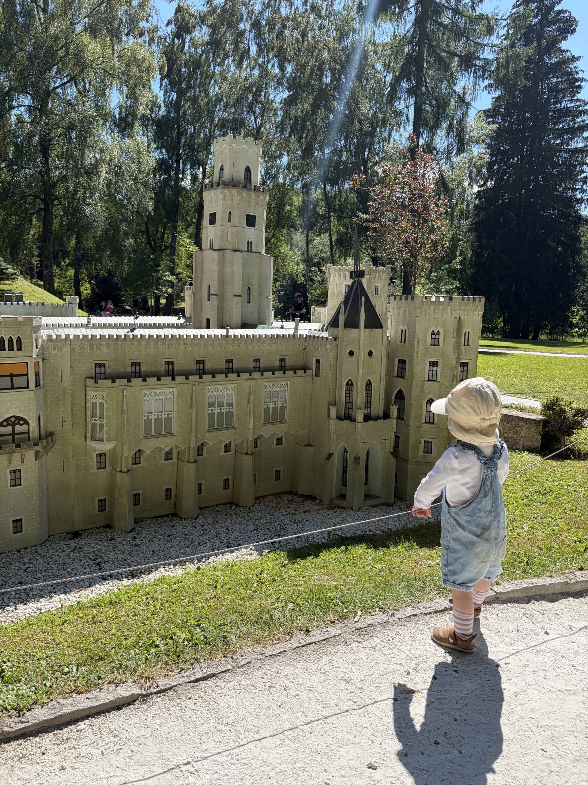 dítě stojí vedle miniatury zámku Hluboká nad Vltavou v parku Boheminium